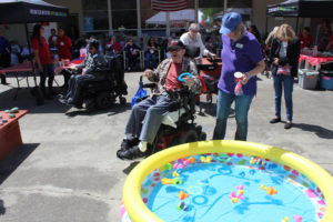 A participant throwing a ring into a pool of rubber ducks 