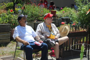 Two participants relaxing and sitting in the sun 