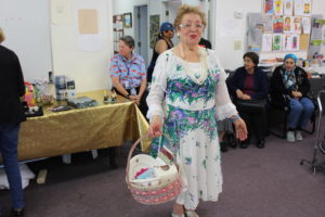 A participant proudly shows off a basket of prizes she won from the carnival